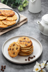 Stack of chocolate chip cookies. Dark background. Sweet delicious snack.
