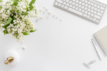 Top view of working space with jasmine flowers and computer keyboard