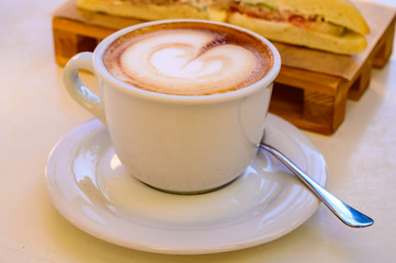 Breakfast coffee, Italian classic cappuccino with milk foam served in cafe