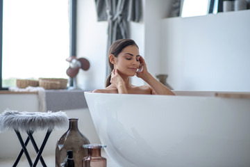 Woman having a bath and looking relaxed