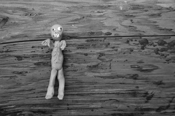 Figure of a zombie on a dark background.