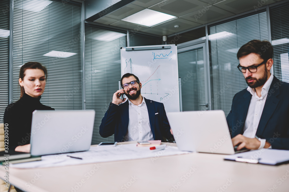Aufkleber successful male executive manager in eyeglasses having mobile conversation in funny atmosphere on mo