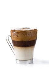 Creamy iced dalgona coffee in glass isolated on white background	