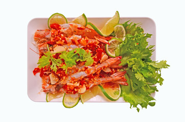 Hot lemon shrimp and vegetable dish on white background