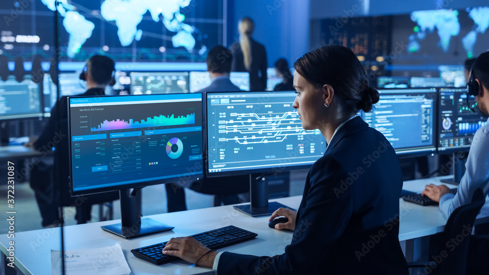 Aufkleber Team of Professional Computer Data Science Engineers Work on Desktops with Screens Showing Charts, Graphs, Infographics, Technical Business Data and Statistics. Dark Control and Monitoring Room.