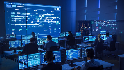Team of Professional Computer Data Science Engineers Work on Desktops with Screens Showing Charts,...