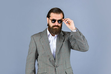 serious bearded man. handsome and successful man in expensive suit. He is in white shirt and...