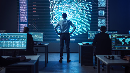 Project manager Stands Next to Big Screen with Neural Network. Team of Professional Computer Data...
