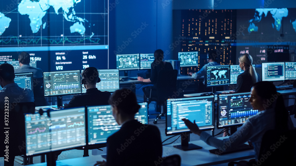 Poster Team of Professional Computer Data Science Engineers Work on Desktops with Screens Showing Charts, Graphs, Infographics, Technical Neural Network Data and Statistics. Dark Control and Monitoring Room.