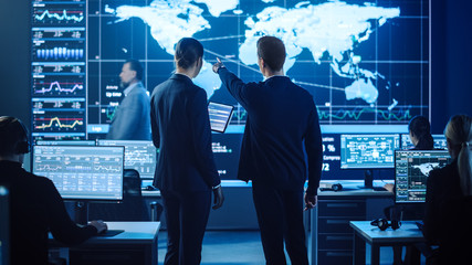 Project Manager and Computer Science Engineer Talking while Using A Digital Tablet Computer....