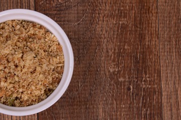 crumbs in bowl on wooden background