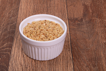 crumbs in bowl on wooden background