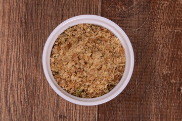 crumbs in bowl on wooden background