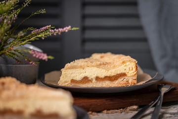 Rustic grated cottage cheese cake with caramel on grey table. Homemade crumb pie. Portion of  organic, healthy, country dessert. Copy space.
