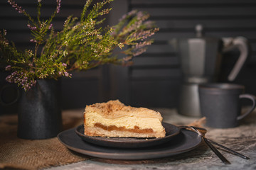 Rustic grated cottage cheese cake with caramel on grey table. Homemade crumb pie. Portion of  organic, healthy, country dessert. Copy space.