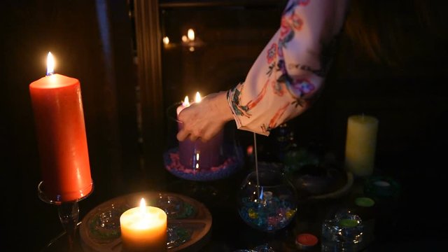 The palmist Lights the candles. A mystical ritual in the clairvoyant's room.