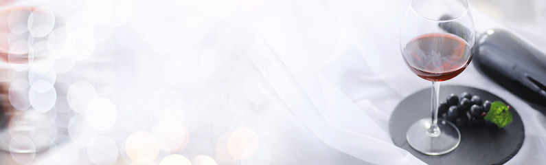 Glass with grape red semi-dry wine. Valentine's day concept background. Gift for the holiday. Sweet sparkling wine.