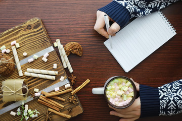 Winter breakfast. A cup of hot chocolate with marshmallows and freshly baked cookies. Gingerbread cookie and coffee.