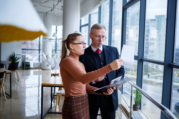 Girl manager in her own office tells a successful new business plan for economic development to her...