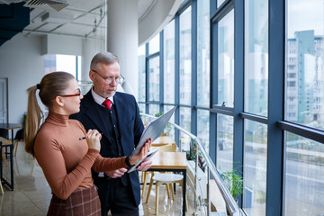 Girl manager in her own office tells a successful new business plan for economic development to her...