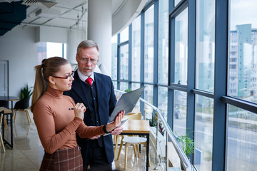 Girl manager in her own office tells a successful new business plan for economic development to her...