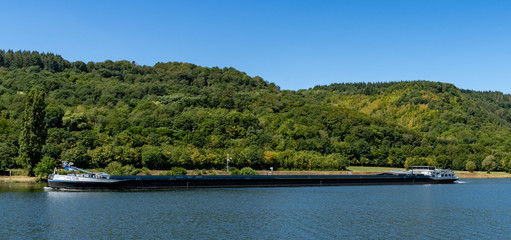 Fototapeta na wymiar large river barge transporting goods on the Moselle River near Enkirch