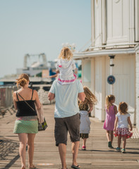 Family of 6 enjoy a day out at Brighton Beach Pier during the Covid-19 pandemic 