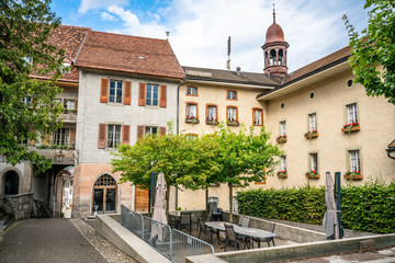 Fototapeta na wymiar Gruyeres medieval village view with pedestrian street and old buildings around a square in La Gruyere Switzerland