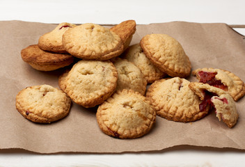 Fototapeta na wymiar homemade round baked cookies on brown paper, delicious dessert