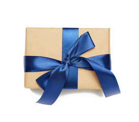 rectangular box wrapped in brown paper and tied with silk ribbon with a bow