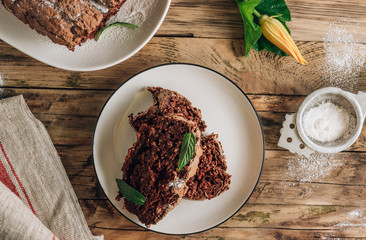Vegan crunchy chocolate zucchini cake on rustic wooden. Healthy gluten free food.