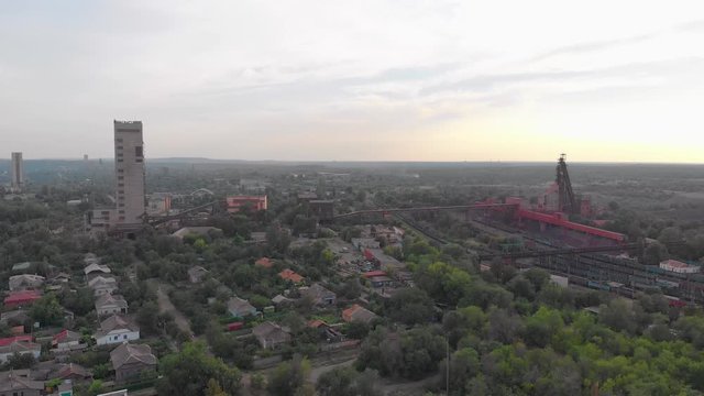 Industrial mine in city red iron ore headframe aerial drone right side camera movement Krivoy Rog Ukraine