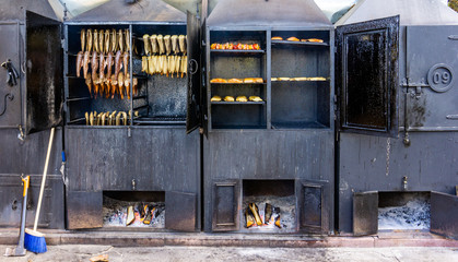 view of fish being smoked in large metal smokers