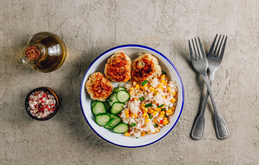 Homemade chicken bowl with rice, corn and cucumber. Healthy balanced eating for lunch.