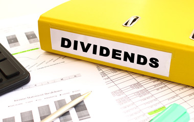 The yellow document folder is on the office desk. Nearby a calculator and finance graphs.