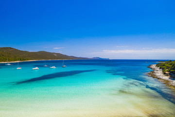 Fototapeta na wymiar Amazing Adriatic coastline in Croatia. Azure turquoise lagoon on Sakarun beach on Dugi Otok island, yachts and sailboats anchored in blue sea.