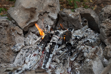 coals of an extinguishing fire, a light is burning.