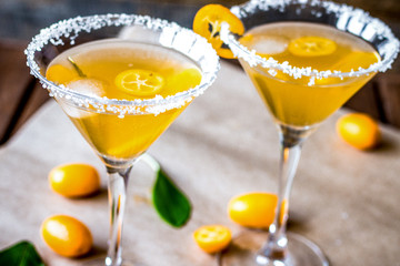 cocktail with kumquat on wooden background