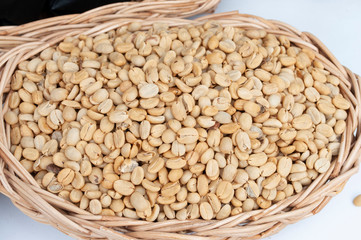 Fresh unroasted coffee beans in the basket