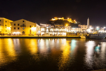 Fototapeta na wymiar Tuscany Maremma Castiglione della Pescaia, fireworks over the sea, panoramic night view of the port and the castle