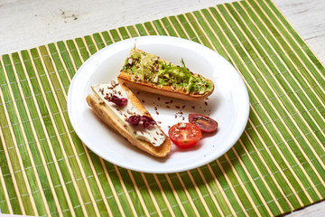 Toasted baguette with avocado and cheese.