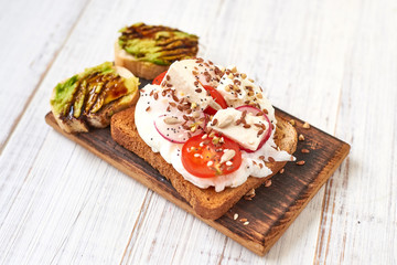 Toasts with eggs, tomatoes, vegetables, avocados and spices.