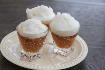 Thai Sago Dessert over topping with coconut milk contain in small glass, appetizing