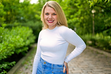 Fototapeta premium Portrait of a woman on sunny summer or spring day outside
