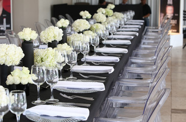 White rose boutiques on a gala dinner table.