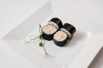 Japanese sushi food. Maki and rolls. Decorated with greenery.