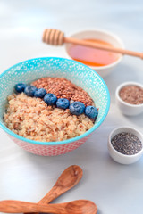 High protein healthy breakfast, buckwheat porridge with blueberries and honey