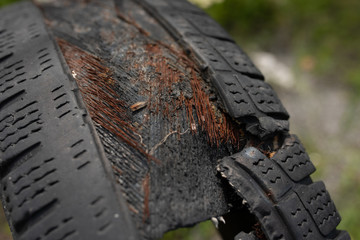 Very old, worn down to the wire, car rubber.