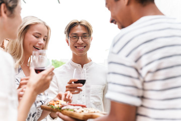 Group of happy cheerful friends having party