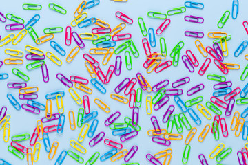 Paper color clip notebook on blue background. Flat lay.